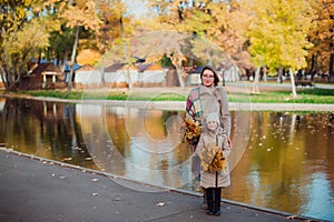 Mom and daughter and walk in the autumn Park near the lake