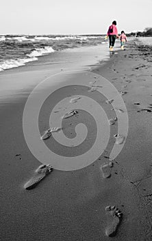 Mom and daughter walk - Footprint in coast