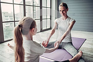 Mom with daughter working out at home