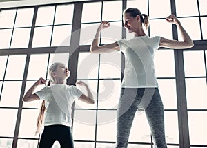 Mom with daughter working out at home photo