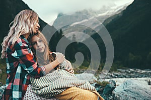 Mom with daughter wrapped in blanket