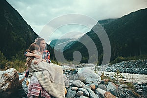 Mom with daughter wrapped in blanket