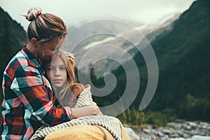 Mom with daughter wrapped in blanket