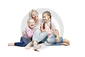 Mom and daughters are sitting and laughing. Love and tenderness. Isolated over white background