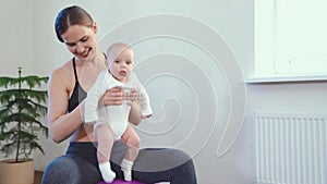 Mom does fitness with the baby at home