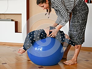 Mom is doing exercises for the baby. Baby and mom develop body motility