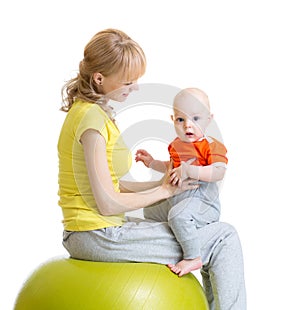 Mom doing exercises on a fit ball with baby.