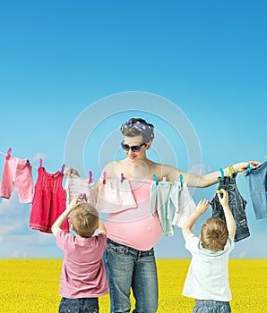 Mom doing the laundry with sons