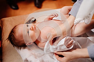 Mom dress their child on a table in the Church. the ordinance of baptism.