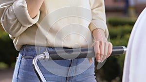 Mom eating fast food, strolling with baby, lacking time to prepare healthy food