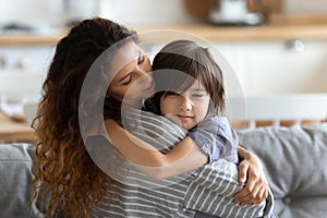 Mom embracing little son express care and love soothing him