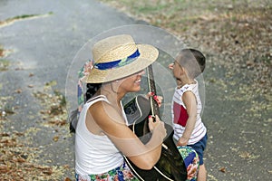 Mom entertains her son while playing guitar