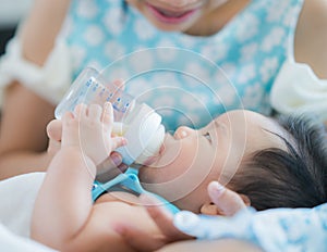 Mom feed power mile to her baby