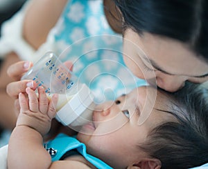 Mom feed power mile to her baby