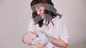 Mom is feeding the baby milk from a bottle