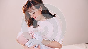 Mom is feeding the baby milk from a bottle