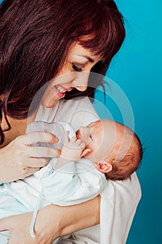 Mom is feeding the baby milk from a bottle