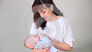 Mom is feeding the baby milk from a bottle of love