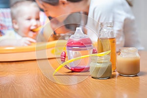 Mom feeds the baby soup. Healthy and natural baby food