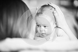 Mom gently the babys head