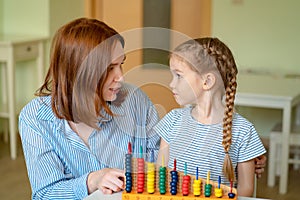 Mom with girl learning to add and subtract photo