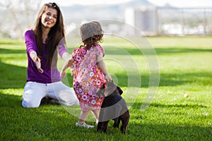 Mom, girl and puppy at the park