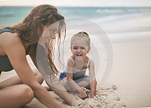 Mom and baby playing near beach. Traveling with family, child