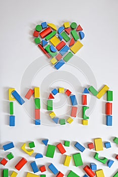 MOM and a heart with colorful wooden toy blocks