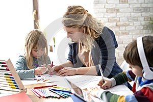 Mom helping her kids with homeschooling during the lockdown