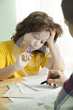 Mom helps my son to do difficult homework