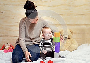 Mom and her Cute Baby Playing with Plastic Blocks