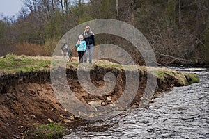 Mom with her daughter and husky dog on a walk on a spring day near the Pirita river in nature