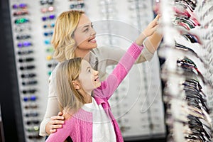 Mom and girl choose beautiful framework for eyeglasses