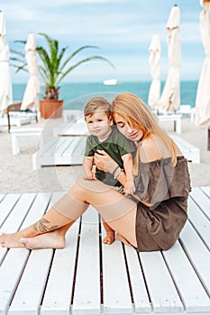 Mom and her little son on the beach, on vacation