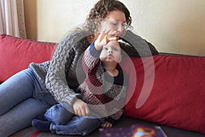 Mom with her little son is reading a book