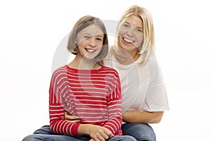 Mom with her teenage daughter hugging and laughing