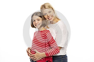 Mom with her teenage daughter hugging and laughing