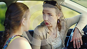 Mom and her teenage daughter are talking seriously in the car. Concept - the problems of adolescents, education