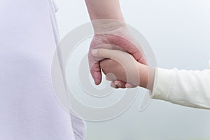 mom holding kids hand close up