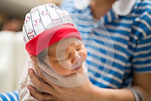 Mom holding newborn baby's in her hand