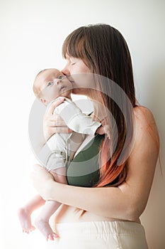 Mom holds the baby in her arms lifestyle . Mother& x27;s love for her son. A newborn baby.