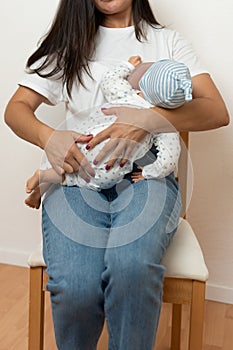 Mom holds a cute baby in her arms. The concept of breastfeeding a newborn baby