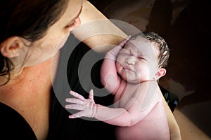 A Mom Holds Her Brand New Son In a Birthing Pool