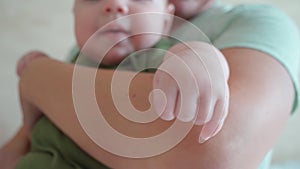 Mom holds a newborn baby in her arms close-up. Infante, New life, love and child protection. Mother's Day. March 8th