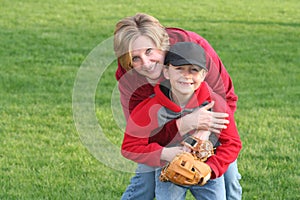 Mom Hugging Young Sports Son photo