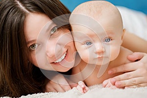 mom hugs the baby on the bed. close-up. maternal love and care.