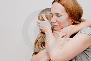 Mom hugs and comforts her little daughter. children& x27;s fears and tantrums.