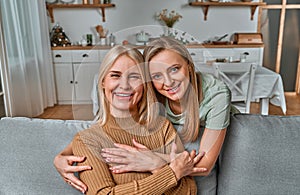 Mom, I am grateful to you for everything, you are the best in the world! an adult daughter hugs her old mother and smiles.Parental