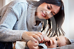 But mom, Im feeling peckish. an adorable baby girl bonding with her mother at home.