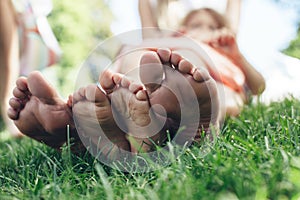 Mom and kid lying on ground in park